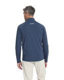 Man wearing a navy blue long-sleeve shirt with a brand logo on the back, standing against a white background.