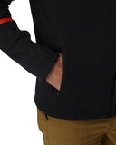 Person wearing a black jacket with a red interior detail, standing against a white background.