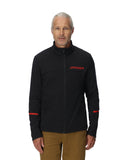 Man wearing a black jacket with a red logo on a white background