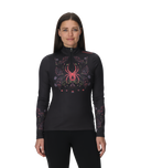 Woman wearing a black long-sleeve top with a colorful spider design on a white background