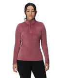 Woman wearing a pink long-sleeve shirt with a brand logo on a white background