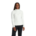 A woman wearing a white Spyder Shimmer Bug half zip fleece top with a crystal logo on the chest.