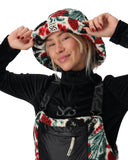 Person wearing a black jacket with floral patterns and a brand logo on a white background