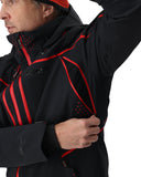 Person wearing a black jacket with red accents on a white background