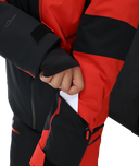 Close-up of a person wearing a black and red jacket with a visible brand logo.