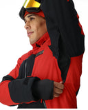 Person wearing a red and black jacket with goggles on their head against a white background