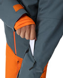 Close-up of a gray and orange jacket with a hand adjusting the sleeve.