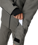 Gray snow pants with black zippers and patches on a white background