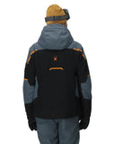 Person wearing a black and gray jacket with orange accents on a white background