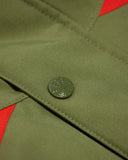 Close-up of a green button on a green fabric background