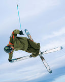 Skier performing a trick against a blue sky