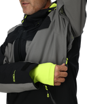 Close-up of a person wearing a gray and black jacket with neon yellow accents.