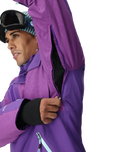 Person wearing a purple jacket with a white background