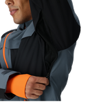 Person wearing a dark gray and orange jacket with a hood