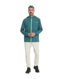 Man wearing a teal rain jacket with a yellow zipper on a white background