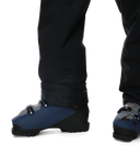 Blue ski boots with black gaiters worn by a person on a white background
