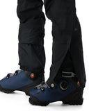 Blue ski boots with black pants on a white background