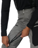 Person wearing gray pants with a black jacket on a white background