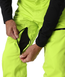 Person wearing bright yellow pants with a black zipper pocket on a white background