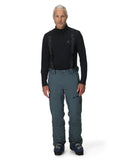 Man wearing a black long-sleeve top and gray pants on a white background