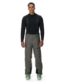 Man wearing a black jacket and gray pants on a white background