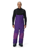 Person wearing a black top and purple snow pants on a white background