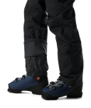 Blue ski boots with black pants on a white background