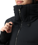 Close-up of a person wearing a black jacket with a hood.