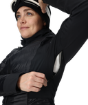 Person wearing a black jacket and helmet on a white background