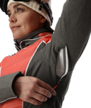 Person wearing a gray and red jacket with a white background