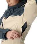 Close-up of a person wearing a two-tone jacket with a visible brand logo.