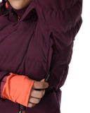 Close-up of a person wearing a dark purple jacket with orange cuffs on a white background