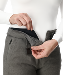 Person wearing gray pants with a white shirt, focusing on the waist area.