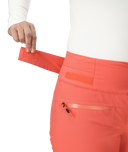Coral pants with a visible brand logo on a white background
