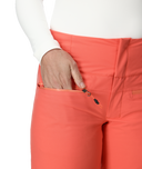 Coral pants with a white shirt on a plain background