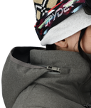 Person wearing a gray jacket with a brand logo on a white background