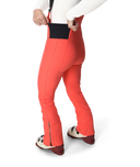Person wearing bright orange ski pants on a white background
