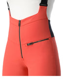 Coral pink bib overalls with black zippers on a white background