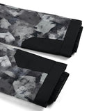 Black and gray patterned blanket with textured surface on a white background