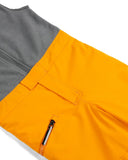 Close-up of orange and gray pants with a pocket and zipper.