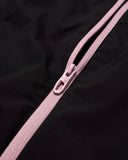 Close-up of a pink zipper on a black background