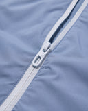 Close-up of a zipper on a blue fabric background