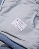 Close-up of a Spyder label on a light gray jacket