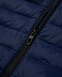 Close-up of a navy blue puffer jacket with a black zipper.
