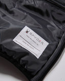 Spyder label on a black jacket with a spider logo