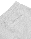 Close-up of a textured gray fabric with a pocket detail on a white background