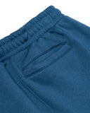 Close-up of blue sweatpants with a white background