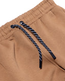 Close-up of brown pants with a drawstring on a white background