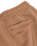 Close-up of brown pants with a pocket on a white background