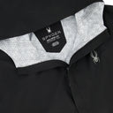 Close-up of a black jacket with white geometric patterned lining and Spyder logo.